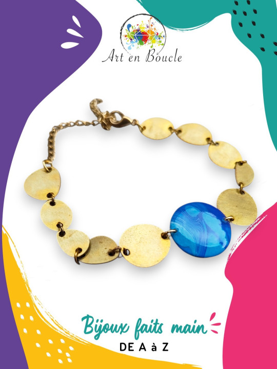 Bracelet artisanal composé de formes arrondies en laiton et perle de tableau bleue