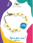 Bracelet artisanal composé de formes arrondies en laiton et perle de tableau bleue